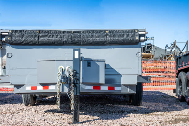 Selective focus on gooseneck trailer hitch with a row of flatbeds lined up. . High quality photo